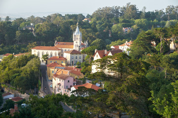 Fototapeta na wymiar View of Sintra town with fairy building of City Hall among the thick green shade of trees. Portugal