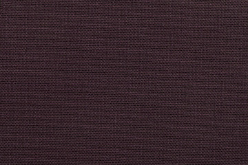 Dark brown background from a textile material with wicker pattern, closeup.