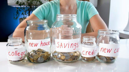 Closeup photo of young woman with lots of money savings for different purposes