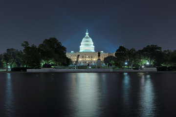 Washington DC. The United States Capitol building with the dome lit up at night. 