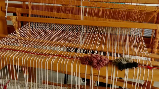 Woman weaving a rug on a wooden loom, 4k Video Clip