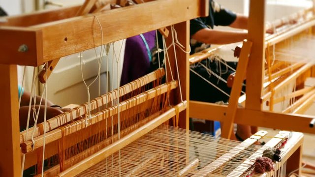 Woman weaving a rug on a wooden loom, 4k Video Clip