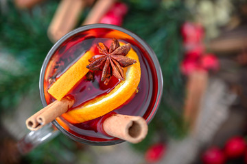 Hot wine with spices on christmas table with decoration