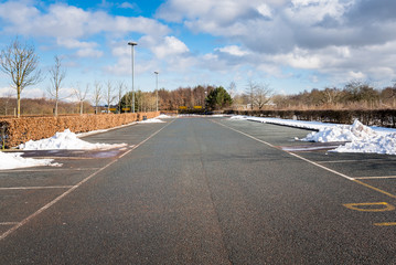 Empty Car Park Cleared of Snow under a Blue Sky with Clouds on a Winter Day. Falkirk, Scotland