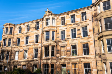 Fototapeta na wymiar Traditional Stone Town House under Blue Sky in Edinburgh City Centre on a Sunny Winter Day