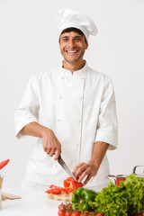 Chef man isolated over white wall background cooking.