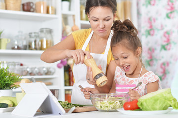 Portrait of young woman preparing dinner in kitchen