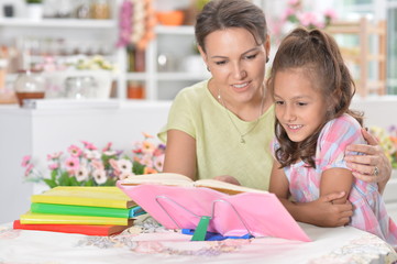 little girl with her mother doing homework