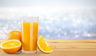 Orange juice with fresh fruits on background