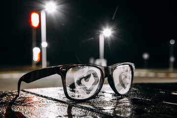 Black glasses on the table at night