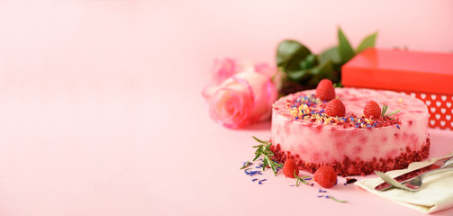 Gift boxes, roses, raspberry cake with fresh berries, rosemary and dry flowers on pink background....