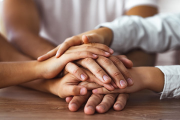 The family hold hands together at the table