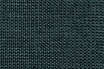 Green background with braided checkered pattern, closeup. Texture of the weaving fabric, macro.