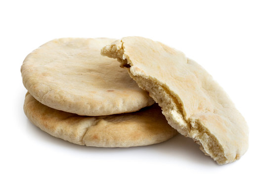 Two and half plain pita breads isolated on white from above.