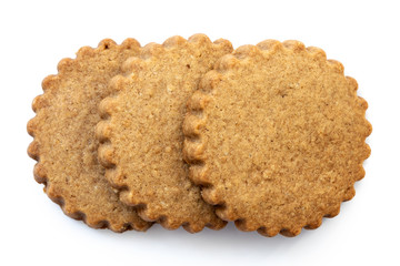 Three round gingerbread biscuits isolated on white from above. Serrated edge.