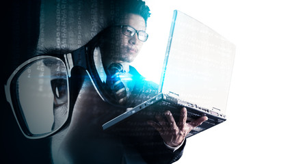 The double exposure image of the businessman using a laptop overlay with source code and programmer image and copy space. The concept of programming, cyber security, business and internet of things.