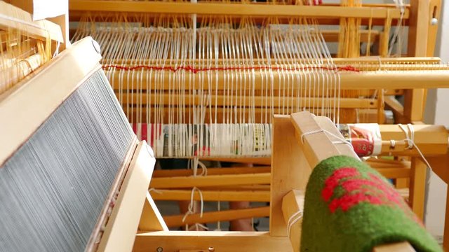 Woman weaving a rug on a wooden loom, 4k Video Clip
