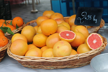 Red grapefruit inside rattan basket on market