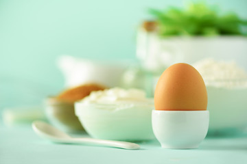White cooking utensils on blue background. Food ingredients. Macro of egg. Cooking cakes and baking bread concept. Copy space.