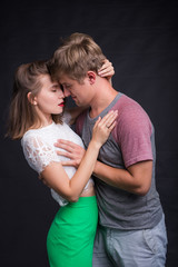 Lovers kissing each other on black background