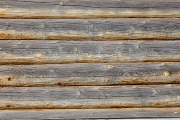 Wall with log house in the house as a background