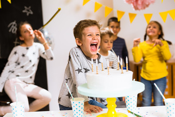 Little boy having fun on his birthday celebration - Powered by Adobe