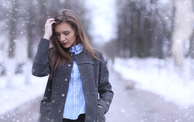 Young girl outdoors in winter. Model girl posing outdoors