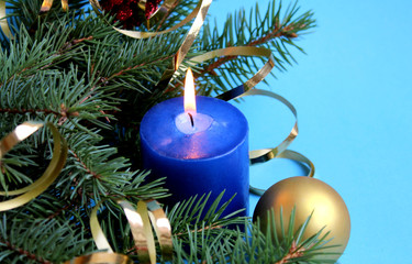 blue candle lit on holiday christmas background