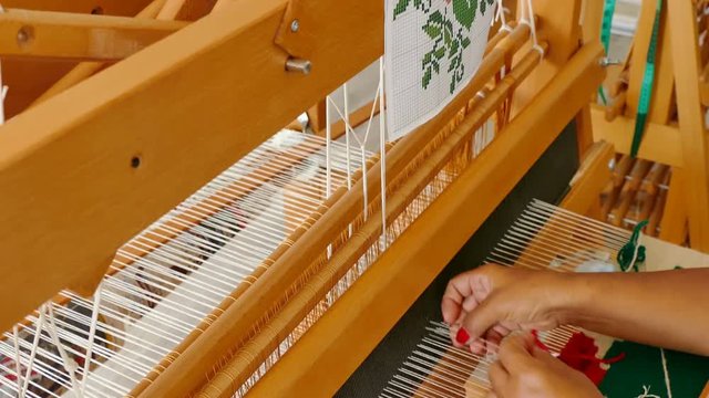 Vrbas, Serbia 21st June 2018:  Women weaving a rug on a wooden loom, 4k Video Clip