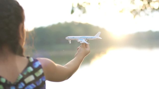little girl playing toy plane