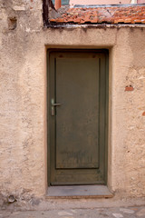 Fototapeta na wymiar external old wooden door and a plaster waal