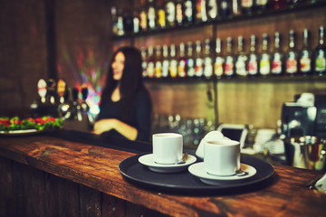 Waiters carrying plates with food, in a restaurant.