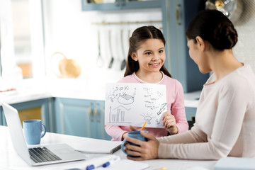 Innovative idea. Inspired creative girl showing picture and woman holding cup