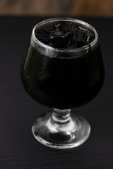 Grass jelly In a glass isolated on table background
