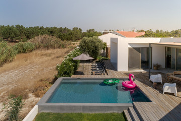 Modern house with garden swimming pool and wooden deck
