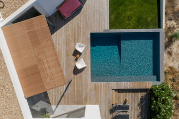 Modern house with garden swimming pool and wooden deck - obrazy, fototapety, plakaty