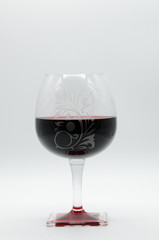 Red wine glass on white