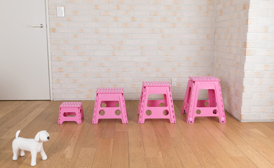 Colorful plastic folding step chair. Over light background. Cozy interior design.