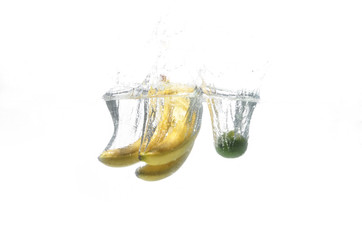 banana and avocado falling into the water.  fruits in water. Aqua shooting