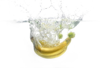 banana and chestnuts fall into the water.  fruit in water. Aqua shooting.  food. yellow bananas