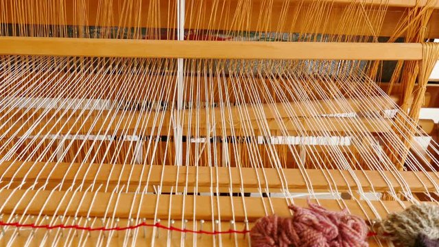 Woman weaving a rug on a wooden loom, 4k Video Clip