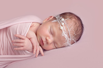 Newborn baby girl in pink