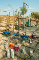Handmade gym on the street: dumbbells, simulators