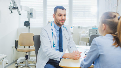 Little Girl Visits Doctor's Office. Friendly Pediartrist Talks with Smart Little Girl. Child Health Examination.