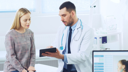 Beautiful Female Visits Doctor's Office, He Shows Tablet Computer with Her Medical History They...