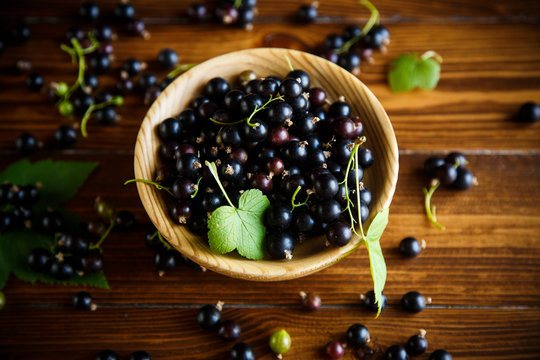 ripe berries black currants on a wooden table