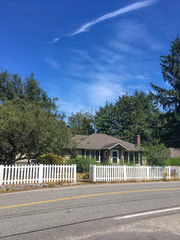 American house with picket fence in forest summer