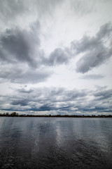 lake shore with grass and trees in spring