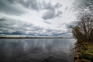 Fototapeta premium lake shore with grass and trees in spring