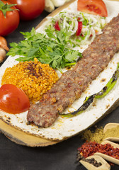 turkish adana kebab with vegetables on the plate